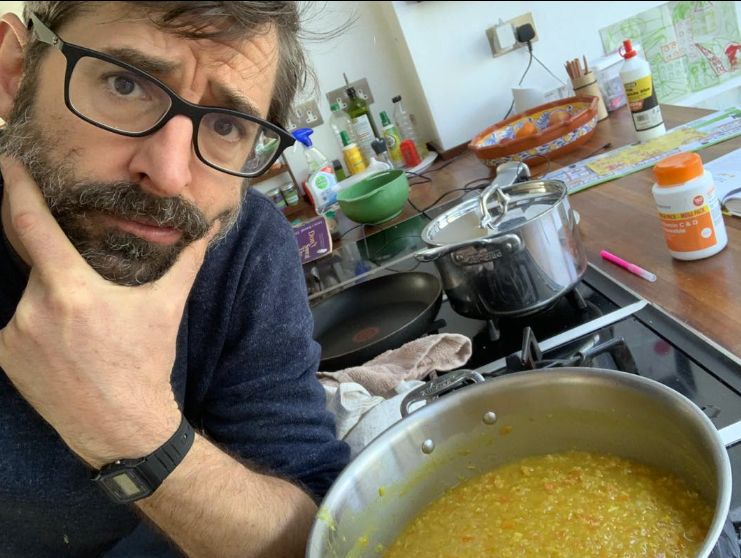 Louis Theroux cooking in a kitchen