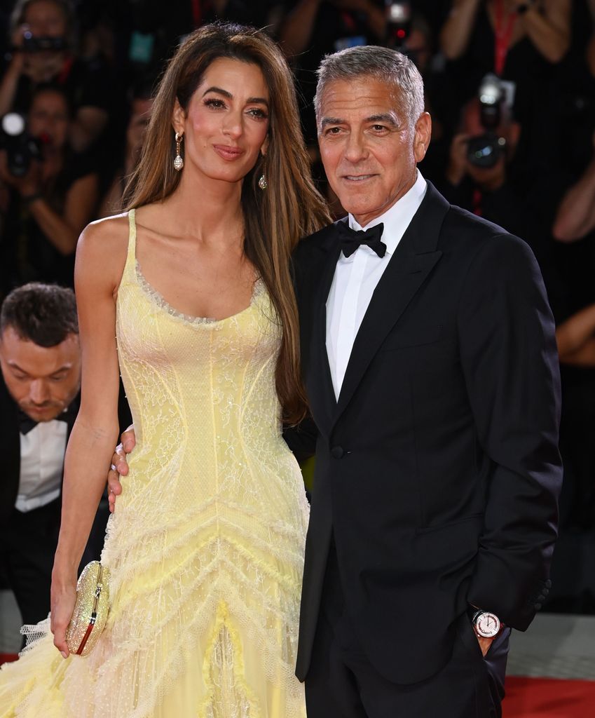 Amal Clooney and George Clooney walk the red carpet arm in arm at the 'Wolfs' premiere, 81st Venice International Film Festival, Italy