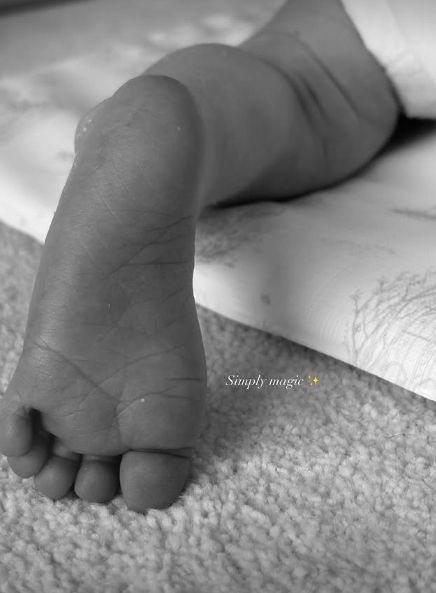 A black-and-white photo of a baby's foot