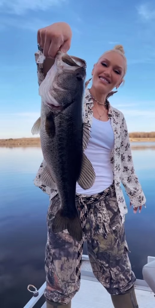 Still from a video shared by Gwen Stefani in which she appears on a lake showing a fish that she caught, March 2025
