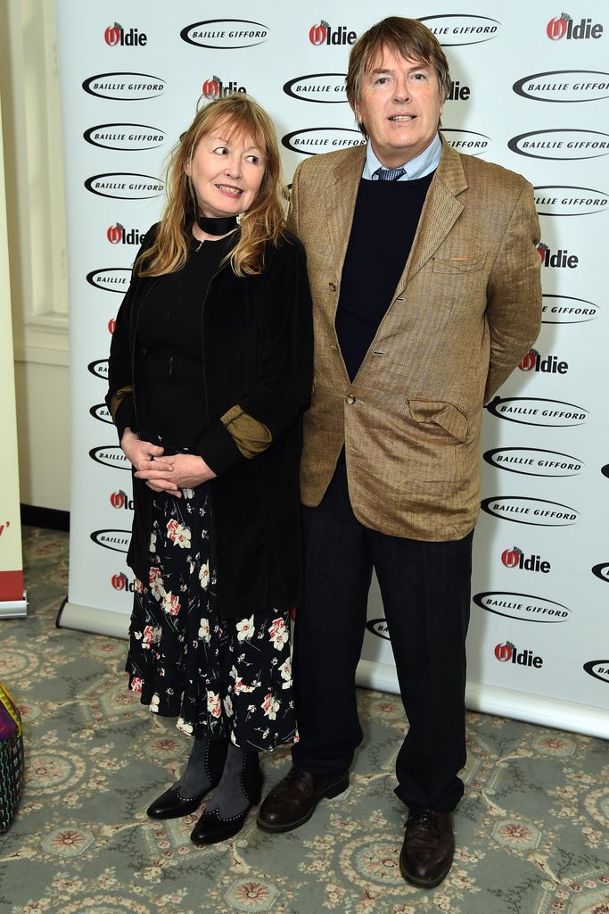Giles Wood in a brown suit jacket and Mary Killen in a floral dress