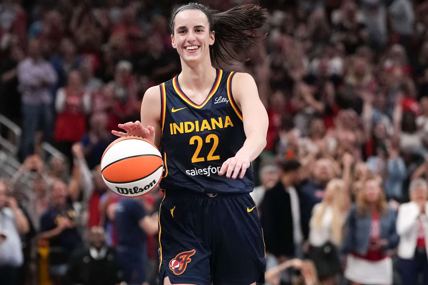 Caitlin Clark 22 of the Indiana Fever celebrates after recording a triple-double in the fourth quarter against the Los Angeles Sparks at Gainbridge Fieldhouse on September 04, 2024 in Indianapolis, Indiana. 