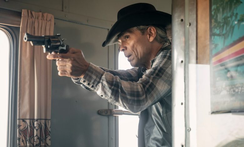 Zahn McClarnon as Joe Leaphorn points a gun on a train in the Dark Winds season three finale.