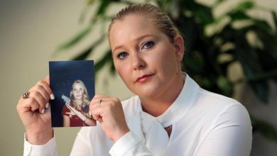 Virginia Giuffre holding a photo of herself as a teen.