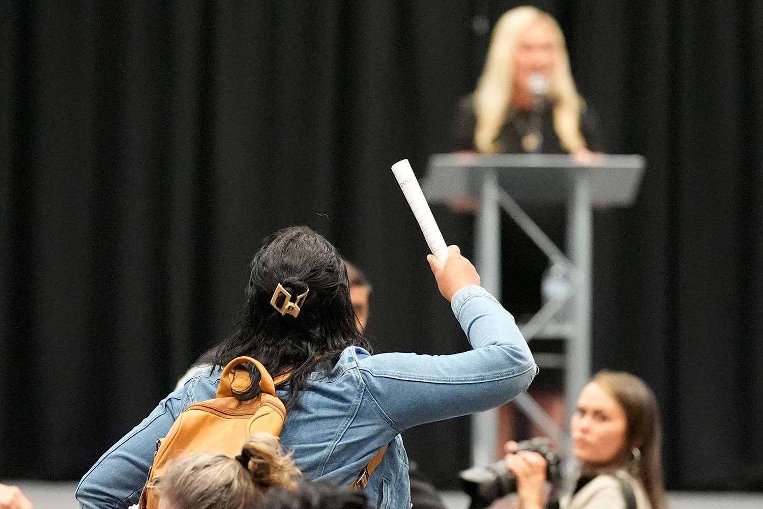 A protester is removed as Rep. Marjorie Taylor Greene, R-Ga., speaks during a town-hall style meeting