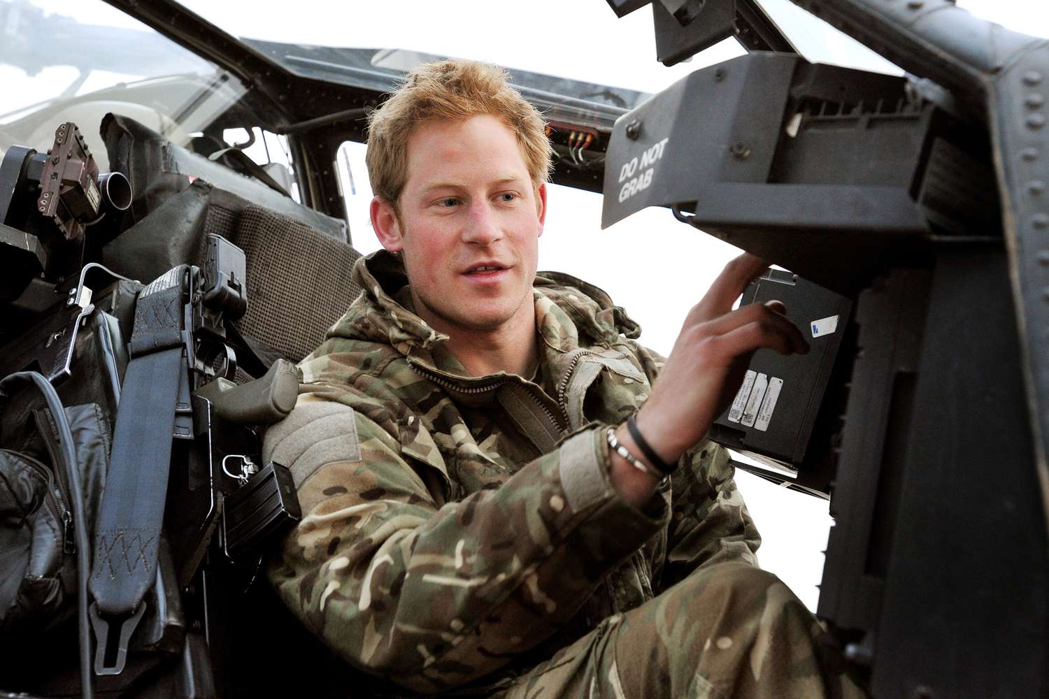 In this image released on January 21, 2013, Prince Harry makes early morning checks as he sits on an Apache helicopter at the British controlled flight-line at Camp Bastion on December 12, 2012 