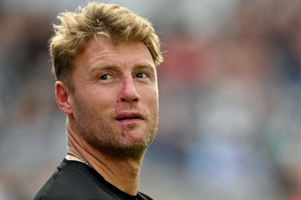 Freddie Flintoff in a black shirt and chain necklace