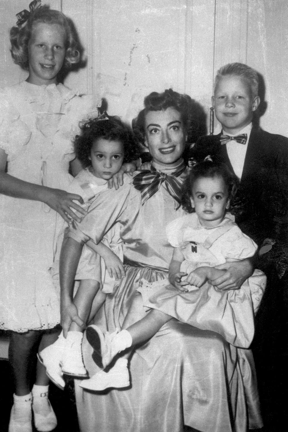 Joan Crawford and her children Christine, Cathy, Cindy and Christopher pose for family portrait on November 13, 1950 in Hollywood, California.