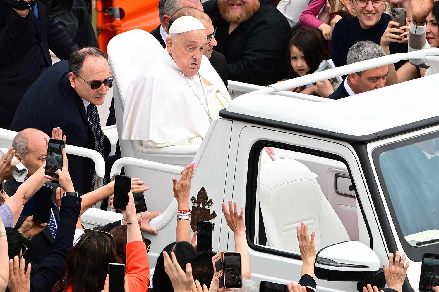Pope Francis waves to the crowd from the popemobile after the Easter mass, at St Peter's square in the Vatican on April 20, 2025.