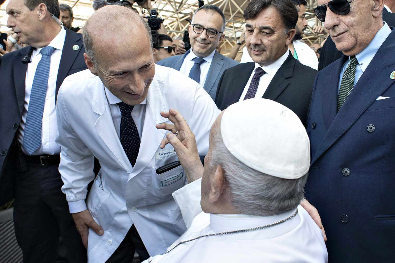 Pope Francis, flanked by surgeon Sergio Alfieri, waves to the faithful as he leaves the Gemelli Hospital after being discharged following surgery on June 16, 2023 in Vatican City, Vatican.