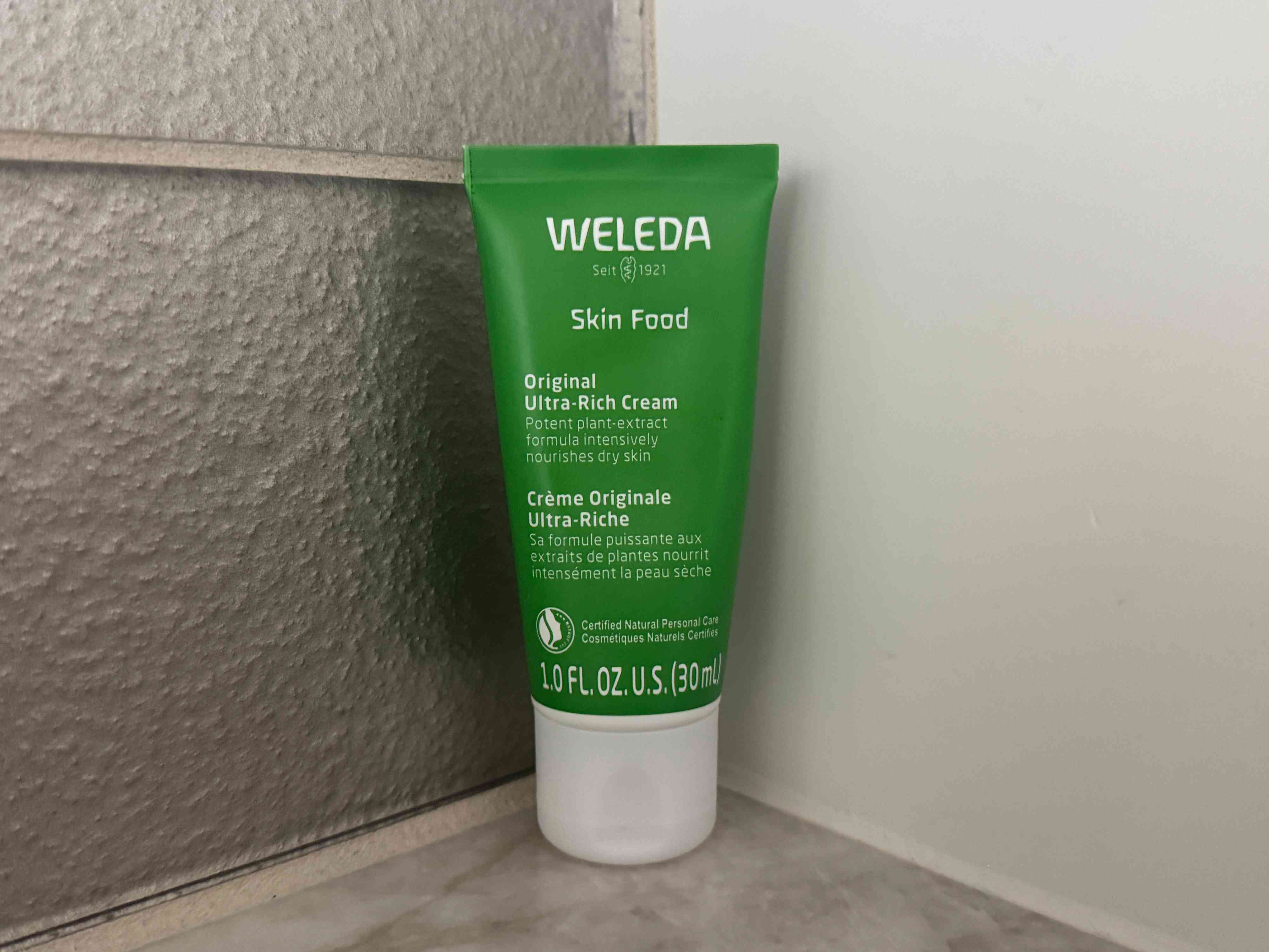 A tube of Weleda Skin Food placed on a surface