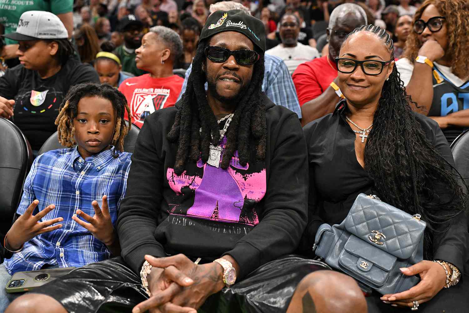 Halo Epps, 2 Chainz, and Kesha Epps attend the game between the Indiana Fever and the Atlanta Dream at State Farm Arena on May 22, 2025 in Atlanta, Georgia.
