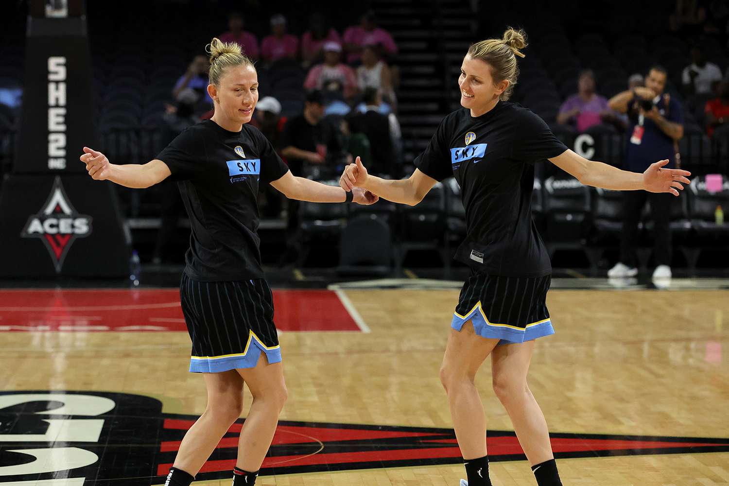 Courtney Vandersloot and Allie Quigley on a basketball court during a warm-up