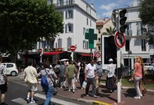 Pedestrians in Cannes cross a street as traffic lights no longer function following Saturday