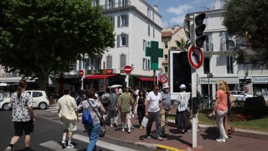 Pedestrians in Cannes cross a street as traffic lights no longer function following Saturday