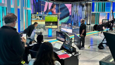 Scott Hanson watches Simone Biles compete in the women
