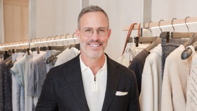 Andrew Weitz poses in a blue suite with a white polo.