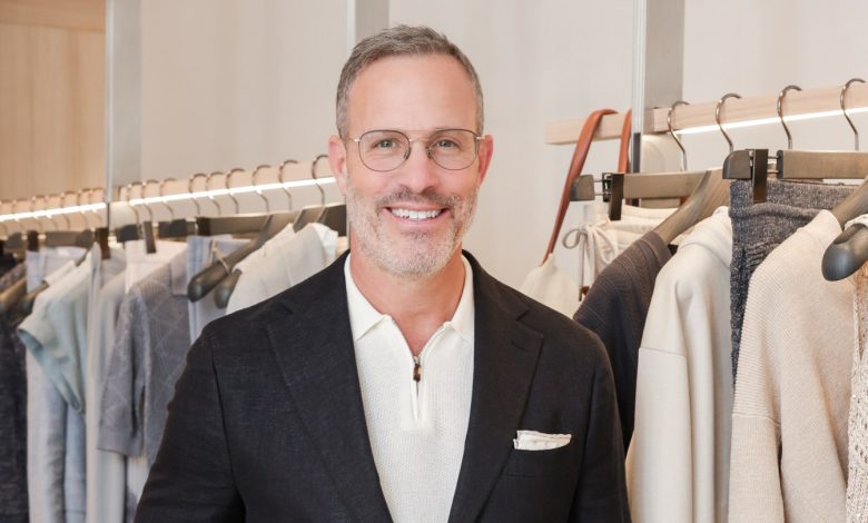 Andrew Weitz poses in a blue suite with a white polo.