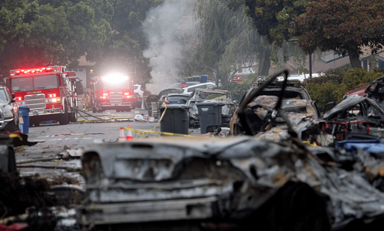 Firefighters work the site where a small plane crashed into a San Diego, California, residential street on May 22, 2025.