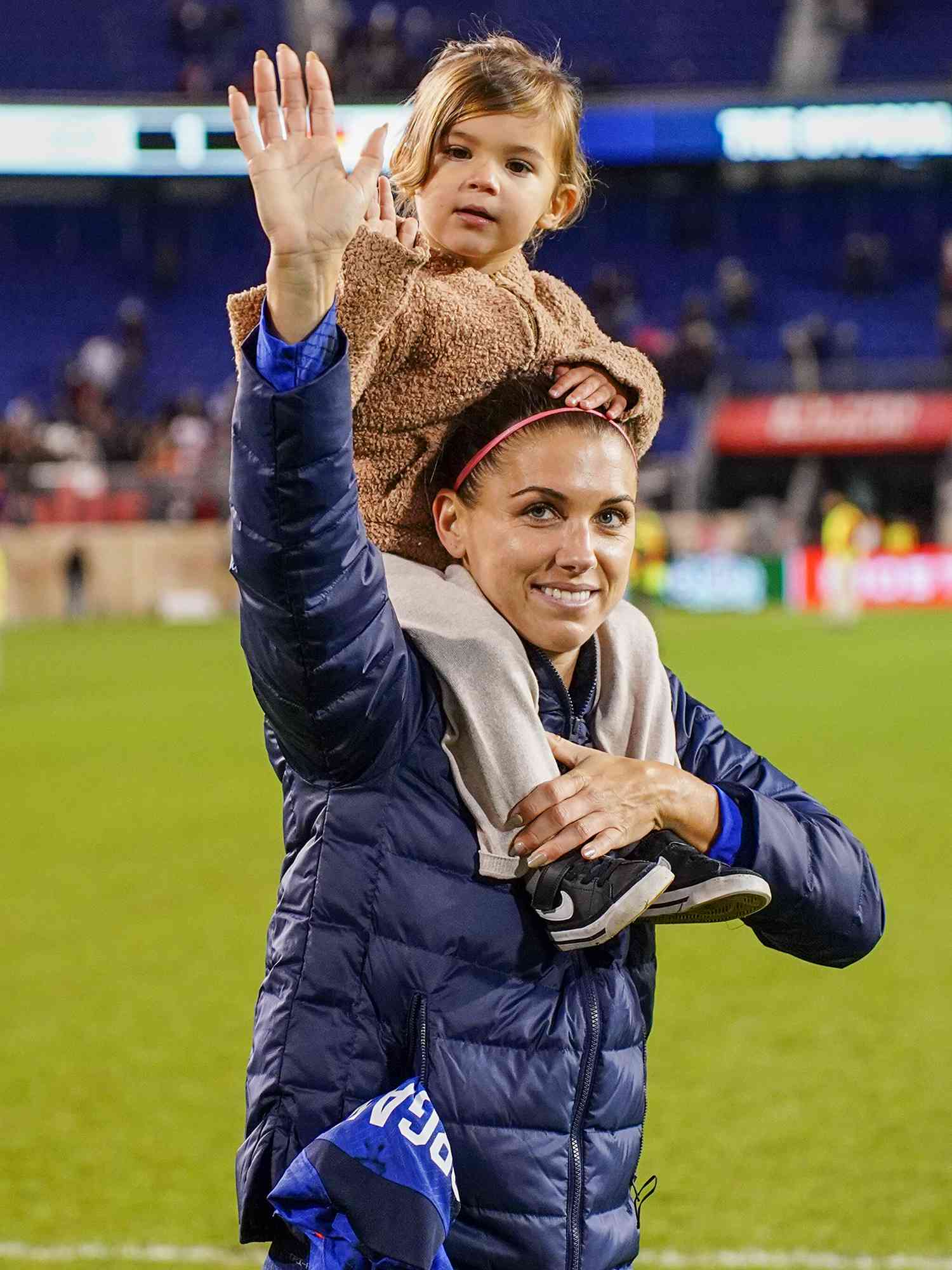 Alex Morgan #13 of the United States with her daughter Charlie Elena Carrasco after a game between Germany and USWNT