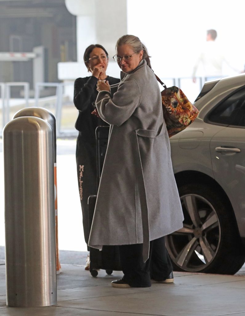 Bridget Fonda at LAX in gray coat