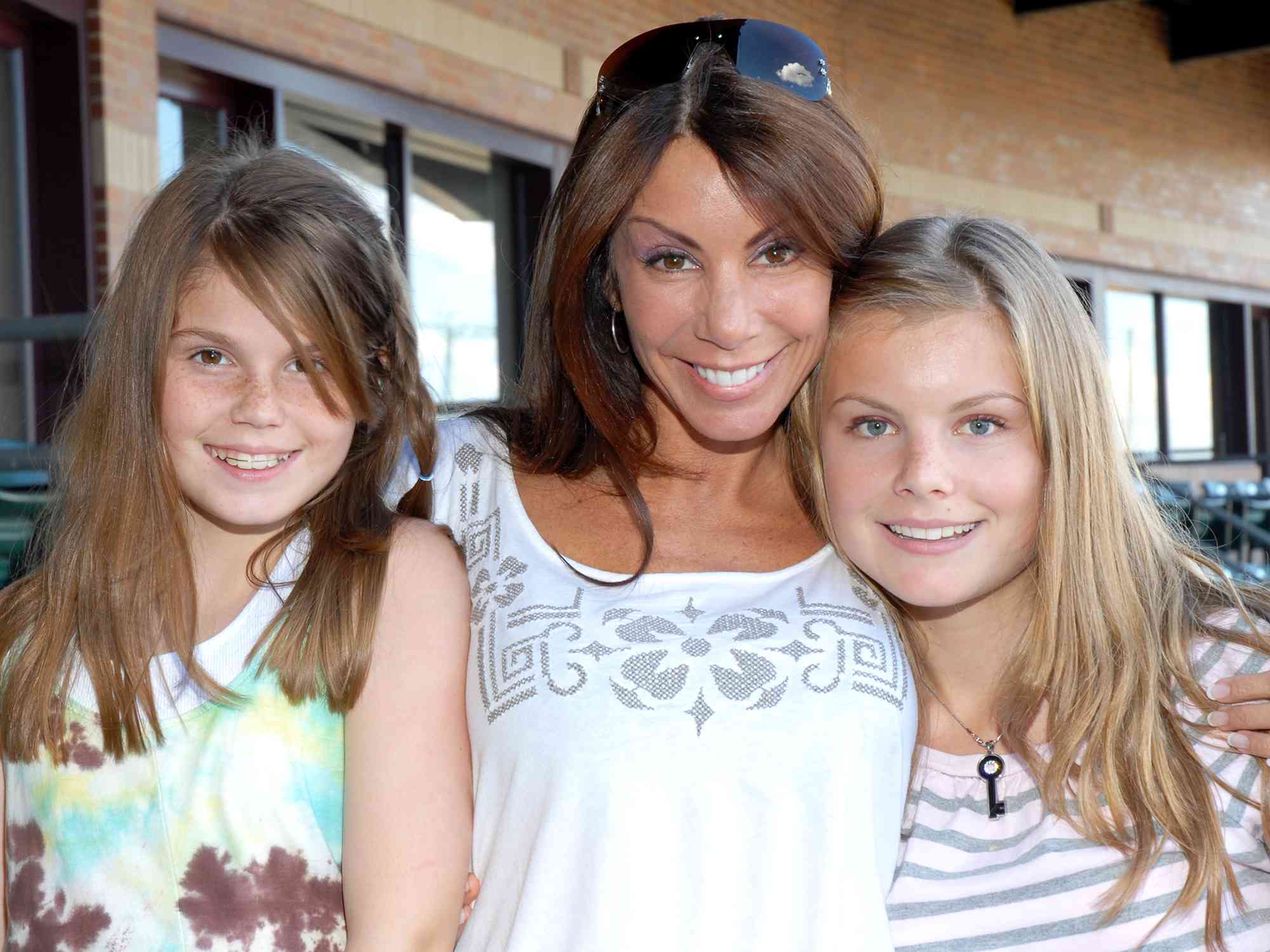 Danielle Staub and daughters Jillian Staub and Christine Staub attend Ladies Night at the Bears & Eagles Riverfront Stadium on July 8, 2009 in Newark, New Jersey.