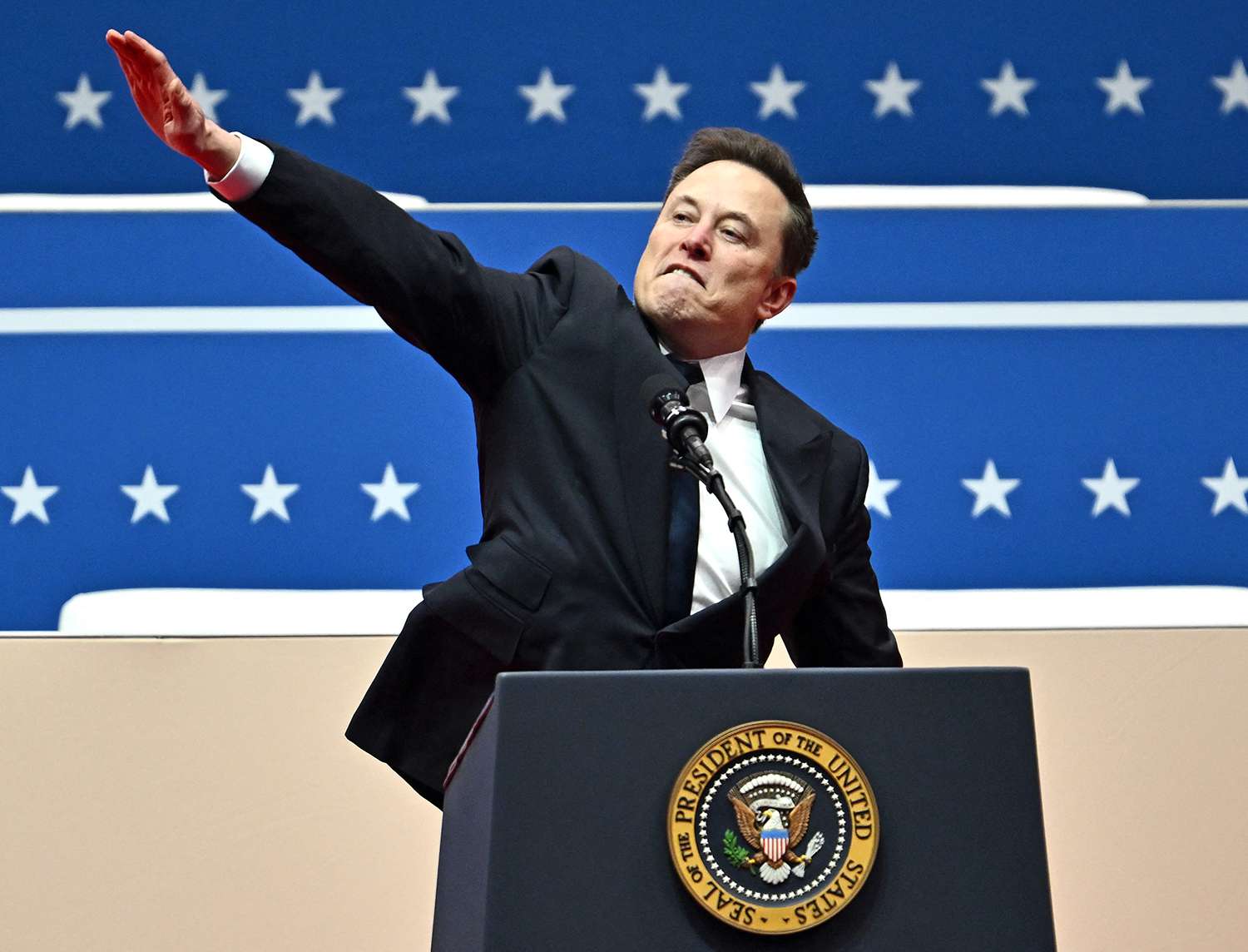Elon Musk gestures as he speaks during the inaugural parade inside Capitol One Arena, in Washington, DC, on January 20, 2025.