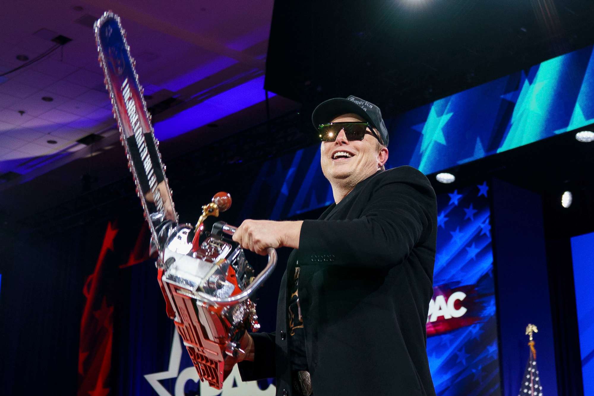 Elon Musk, chief executive officer of Tesla Inc., holds a chainsaw gifted to him by Javier Milei, Argentina's president, not pictured, during the Conservative Political Action Conference (CPAC) in National Harbor, Maryland, US, on Thursday, Feb. 20, 2025. 