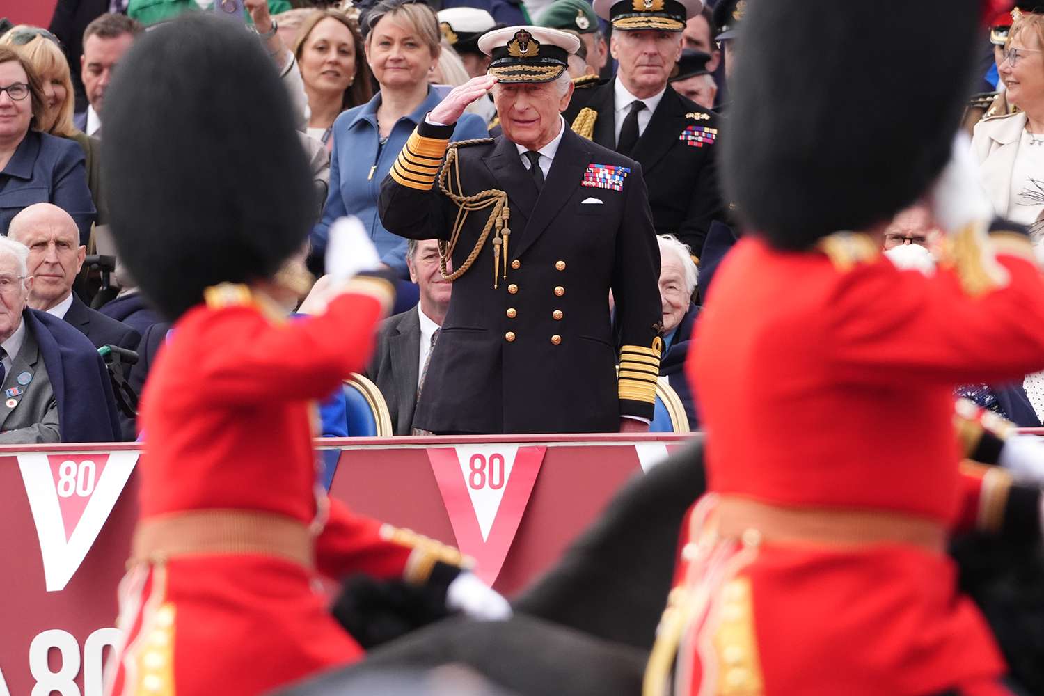 King Charles III takes the salute from the military procession for the 80th anniversary of VE Day