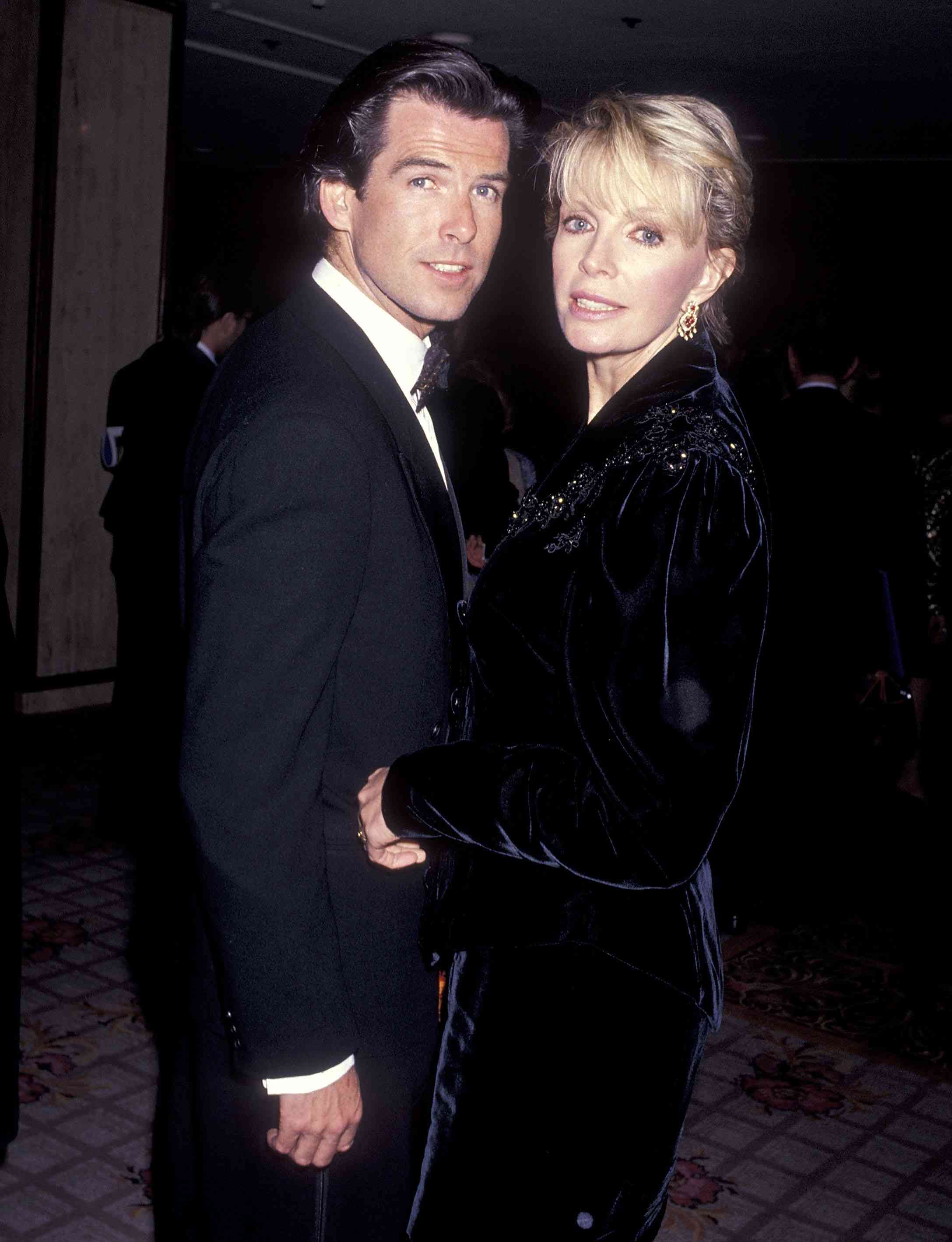 Actor Pierce Brosnan and wife Cassandra Harris attend the California Fashion Industry Friends of AIDS Project Los Angeles Fifth Annual Fashion Show & Dinner Benefit Salute to Gianni Versace on February 13, 1991 at the Century Plaza Hotel in Century City, California. 