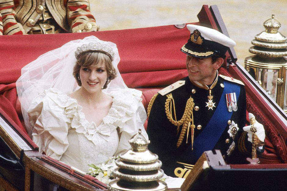 Prince Charles, Prince of Wales and Diana, Princess of Wales, wearing a wedding dress designed by David and Elizabeth Emanuel and the Spencer family Tiara, ride in an open carriage, from St. Paul's Cathedral to Buckingham Palace, following their wedding on July 29, 1981 in London, England