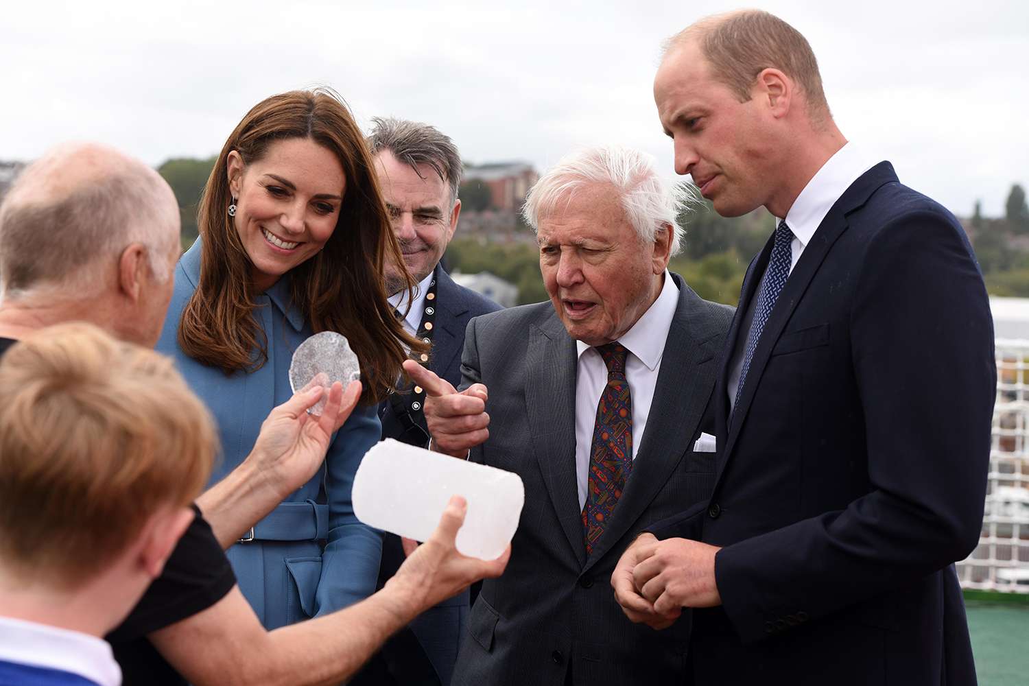 Prince William, Duke of Cambridge, Catherine, Duchess of Cambridge and Sir David Attenborough look at a piece of ice core from the Antarctic during a naming ceremony for the polar research ship the RSS Sir David Attenborough