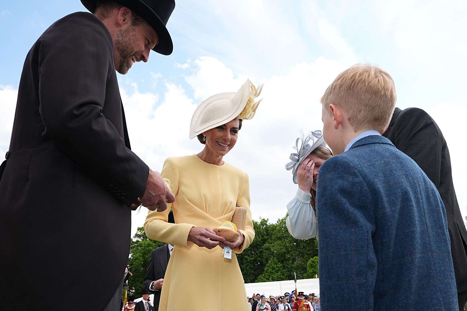  The Prince and Princess of Wales receive Jellycat soft toys and meet the family of Liz Hatton, mother Vicky Robayna, father Aaron and brother Mateo at a Royal Garden Party at Buckingham Palace,