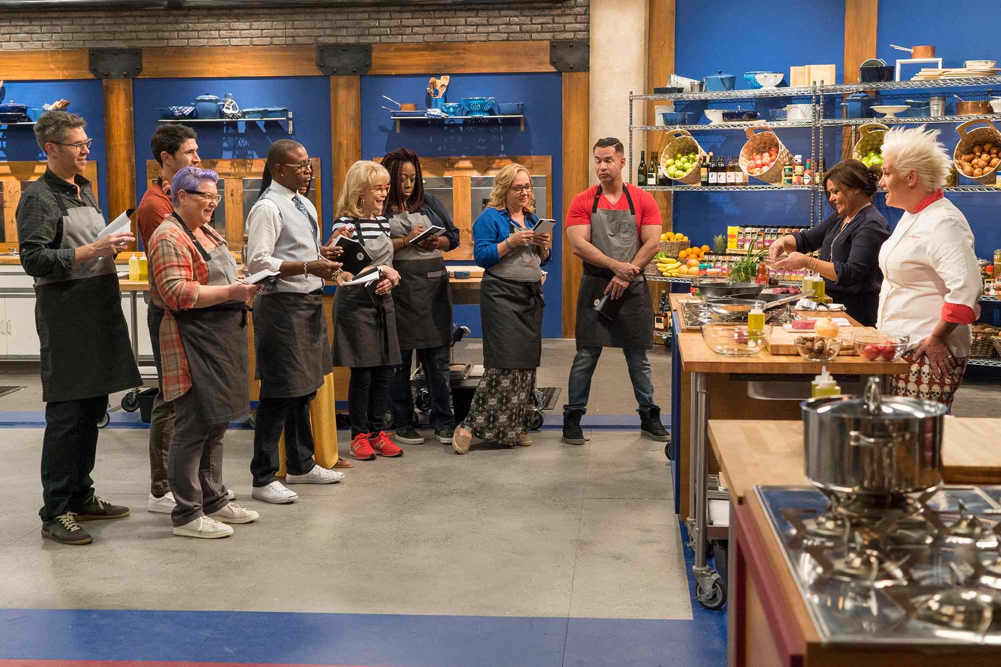 Hosts Rachael Ray and Anne Burrell demonstrate how to make steak and eggs with contestants