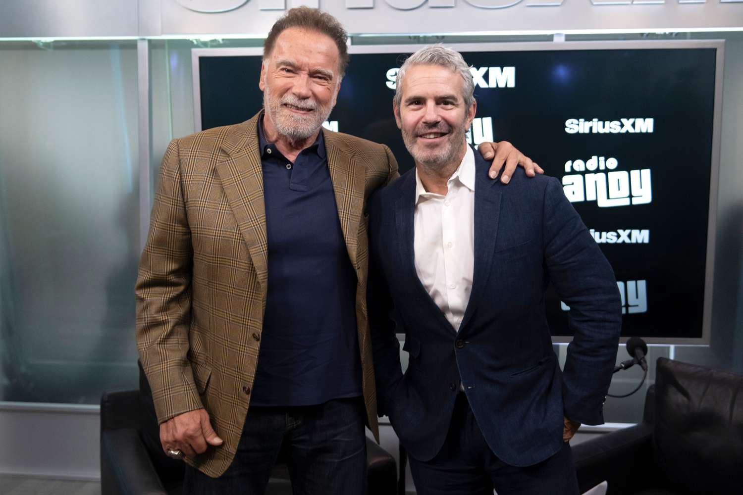 Arnold Schwarzenegger (L) attends a SiriusXM Town Hall hosted by Andy Cohen (R) at SiriusXM Studios on June 