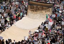 Protesters carry a banner representing the Preamble to the U.S. Constitution in downtown Los Angeles during an anti-Trump "No Kings Day" demonstration in a city that has been the focus of protests against Trump