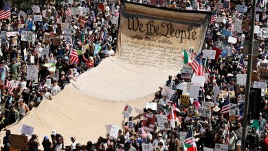 Protesters carry a banner representing the Preamble to the U.S. Constitution in downtown Los Angeles during an anti-Trump "No Kings Day" demonstration in a city that has been the focus of protests against Trump