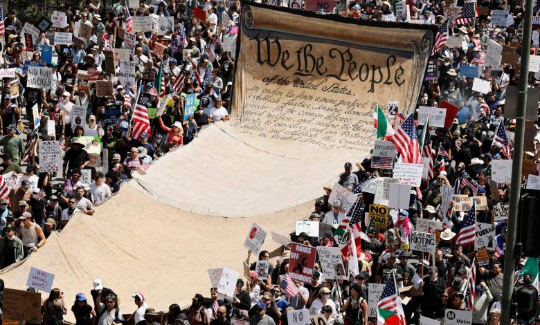 Protesters carry a banner representing the Preamble to the U.S. Constitution in downtown Los Angeles during an anti-Trump "No Kings Day" demonstration in a city that has been the focus of protests against Trump
