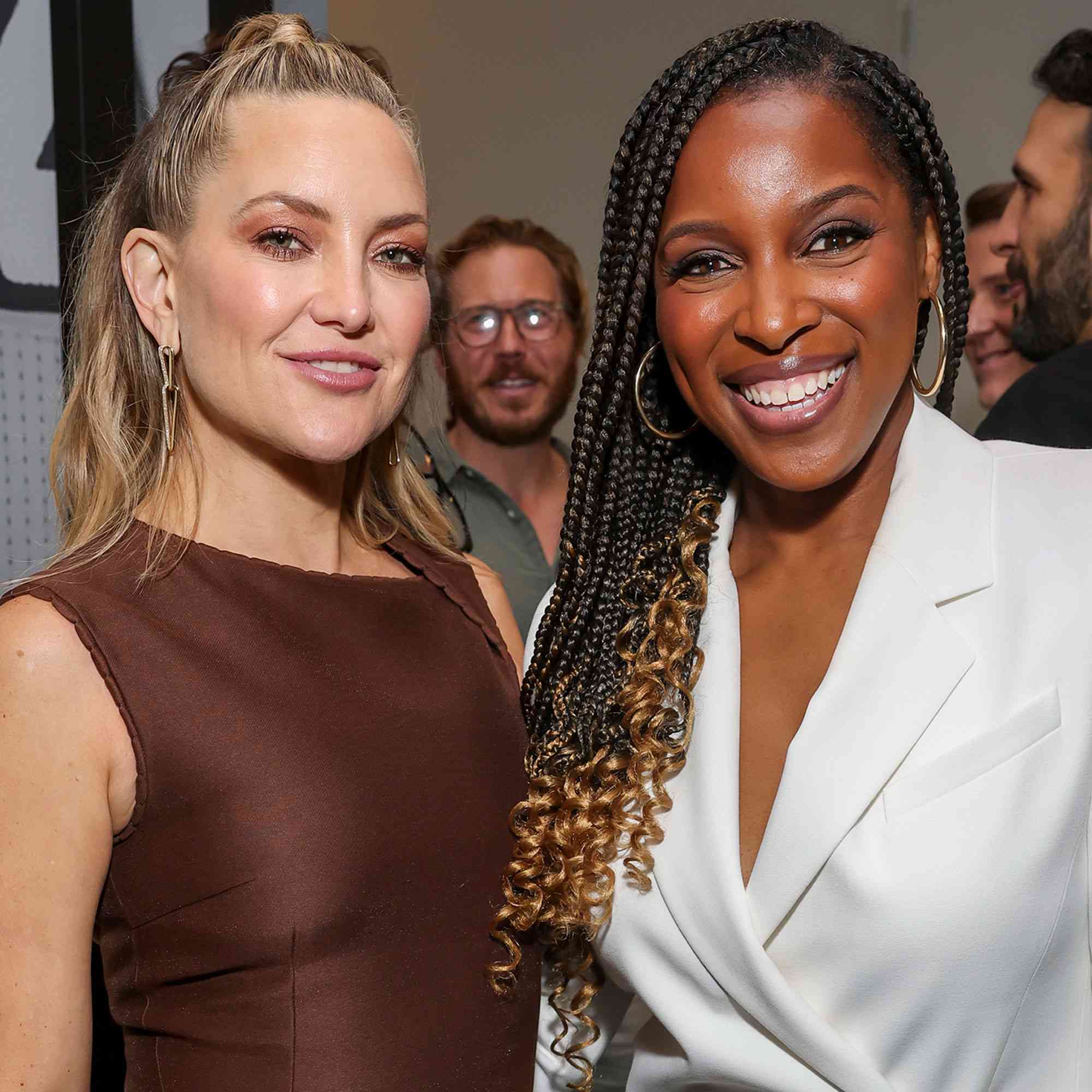 Kate Hudson and another individual smiling at an event
