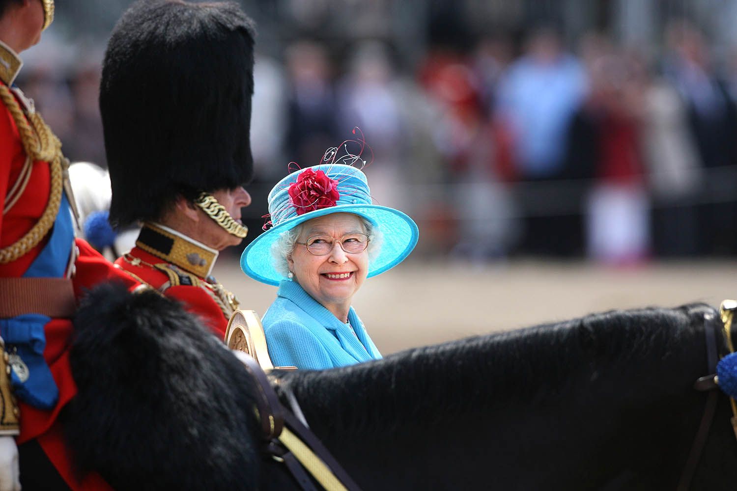 Queen Elizabeth II smiles with the Duke of Edinburgh on Horse Guards Parade during the annual Trooping the Colour parade.