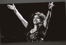 Rebekah Del Rio with her arms up