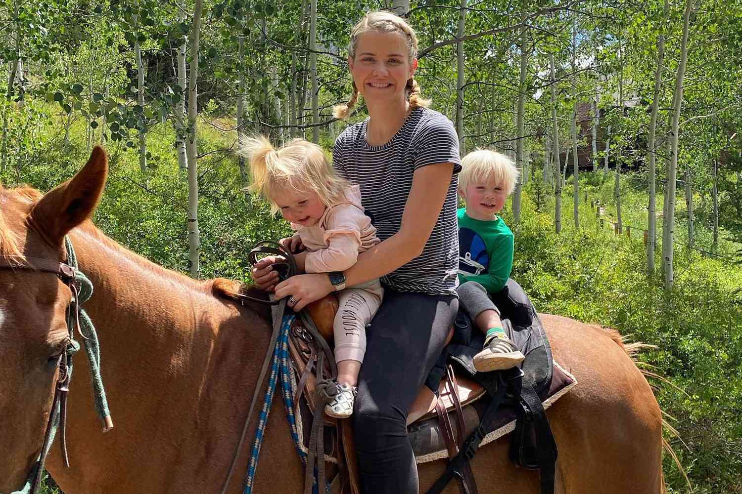 Elizabeth Smart rides a horse with her two kids James and Olivia in July 2020.