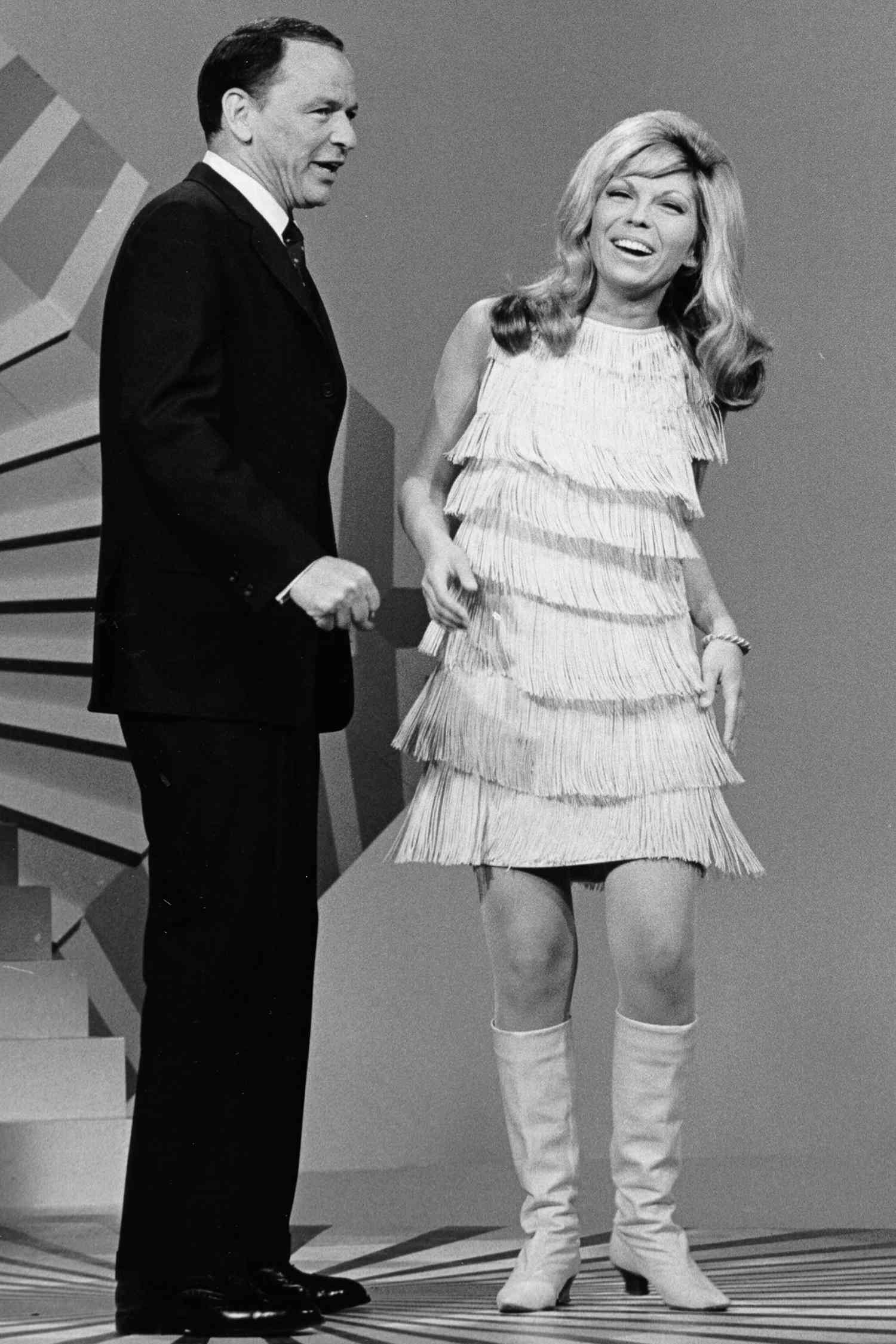 Father and daughter singers Frank Sinatra and Nancy Sinatra perform on a TV show in 1967