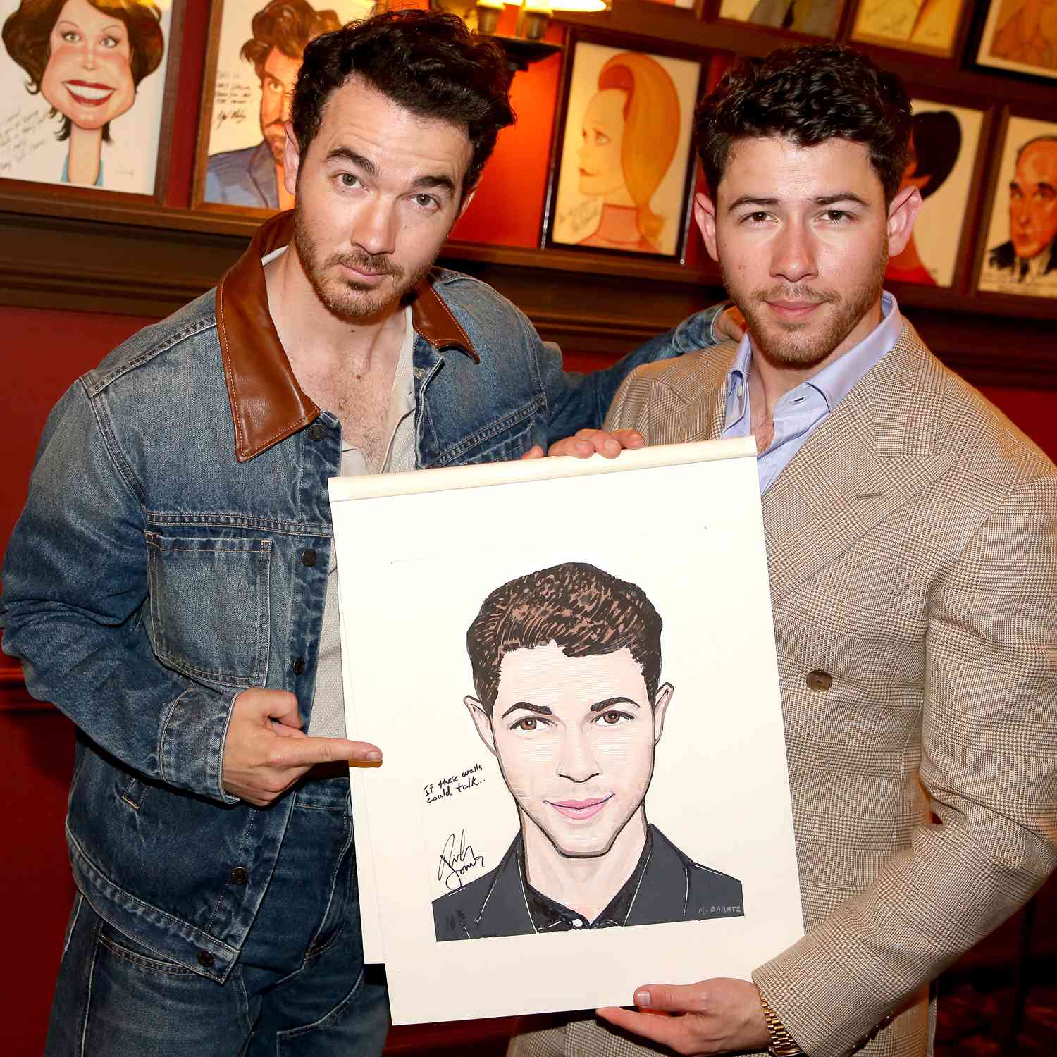 Kevin Jonas and Nick Jonas pose at a portrait dedication honoring Nick Jonas and Adrienne Warren for their 