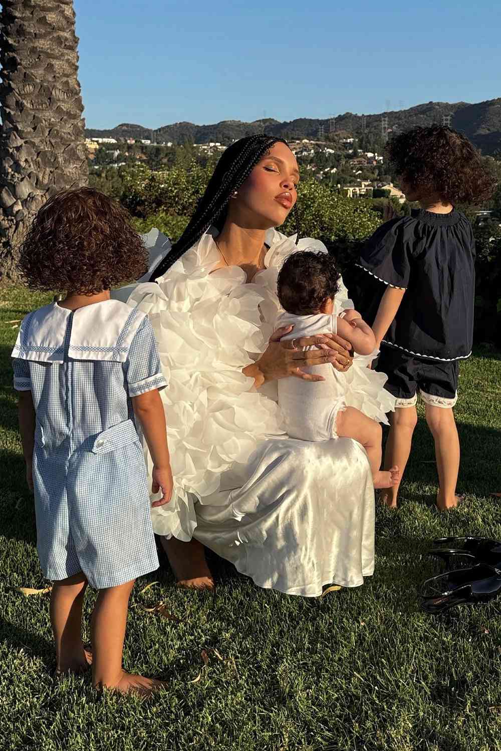 Nara Smith poses for a photo with her 3 children Rumble Honey Smith, Slim Easy Smith, and Whimsy Lou Smith in July 2024.