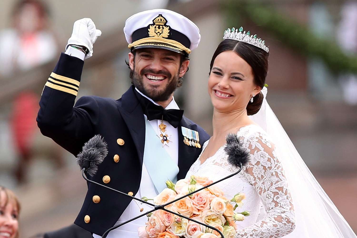 Prince Carl Philip of Sweden and his wife Princess Sofia of Sweden salute the crowd after their marriage ceremony on June 13, 2015 in Stockholm, Sweden