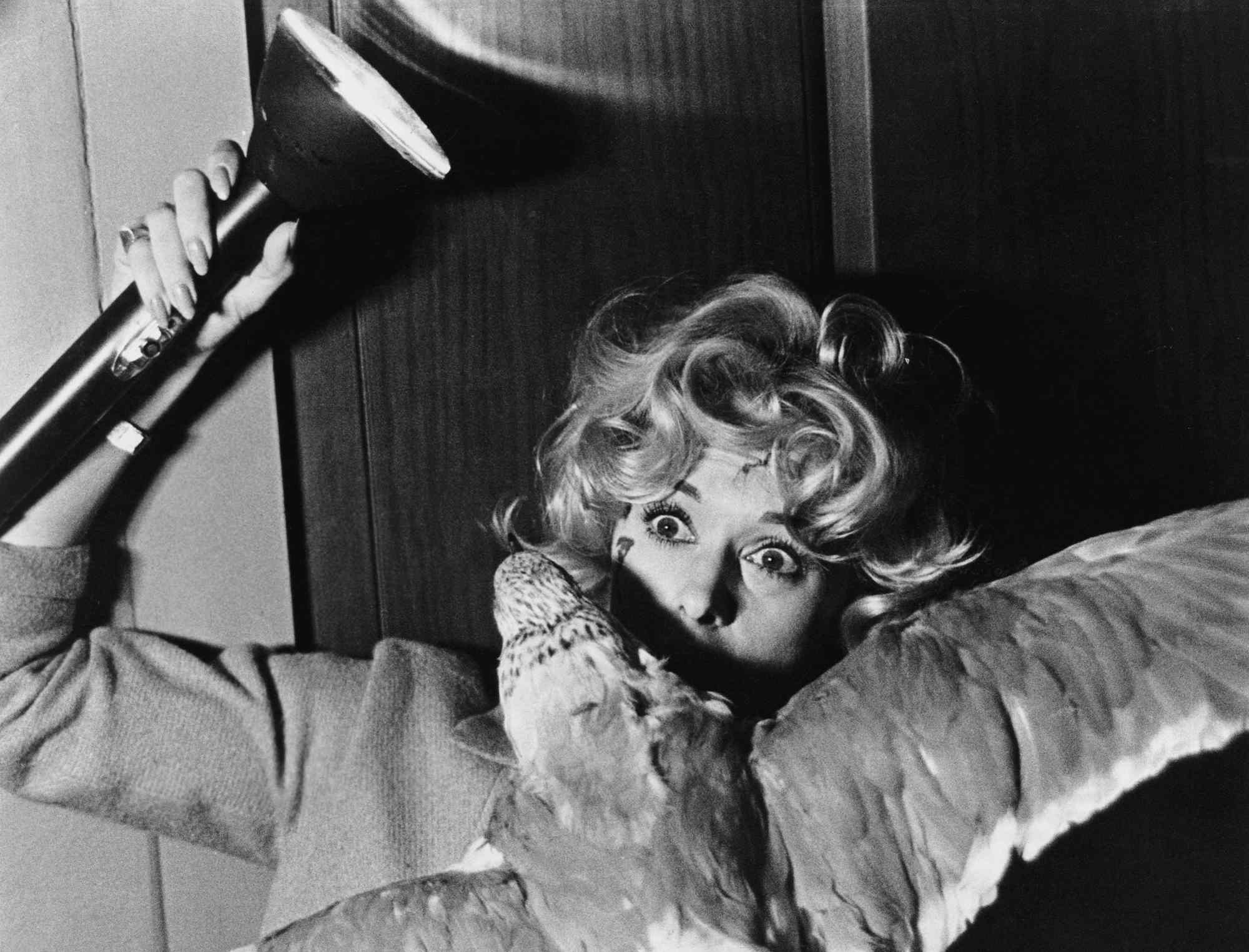 Melanie Daniels (Tippi Hedren) fights off an attacking gull in Alfred Hitchcock's The Birds.