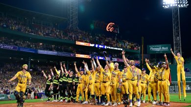 Members of the Savannah Bananas and The Firefighters wave to fans after their game at Fenway Park on July 05, 2025 in Boston, Massachusetts.