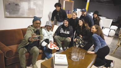 A Sense of Home is furnishing 20 homes a week for displaced families like this one, pictured with volunteers in their newly staged living room.