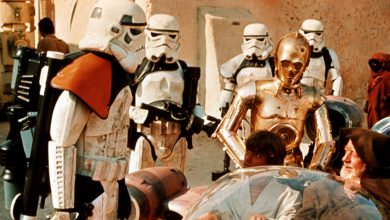 Stormtroopers question Luke Skywalker (Mark Hamill) and Obi-Wan Kenobi (Alec Guinness) on Tatooine in 1977